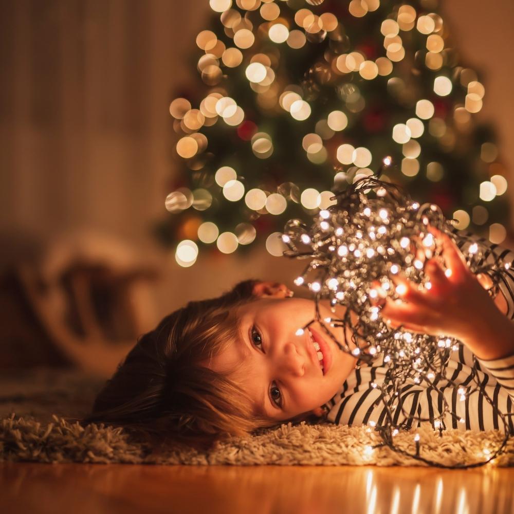 A child holding the christmas lighting