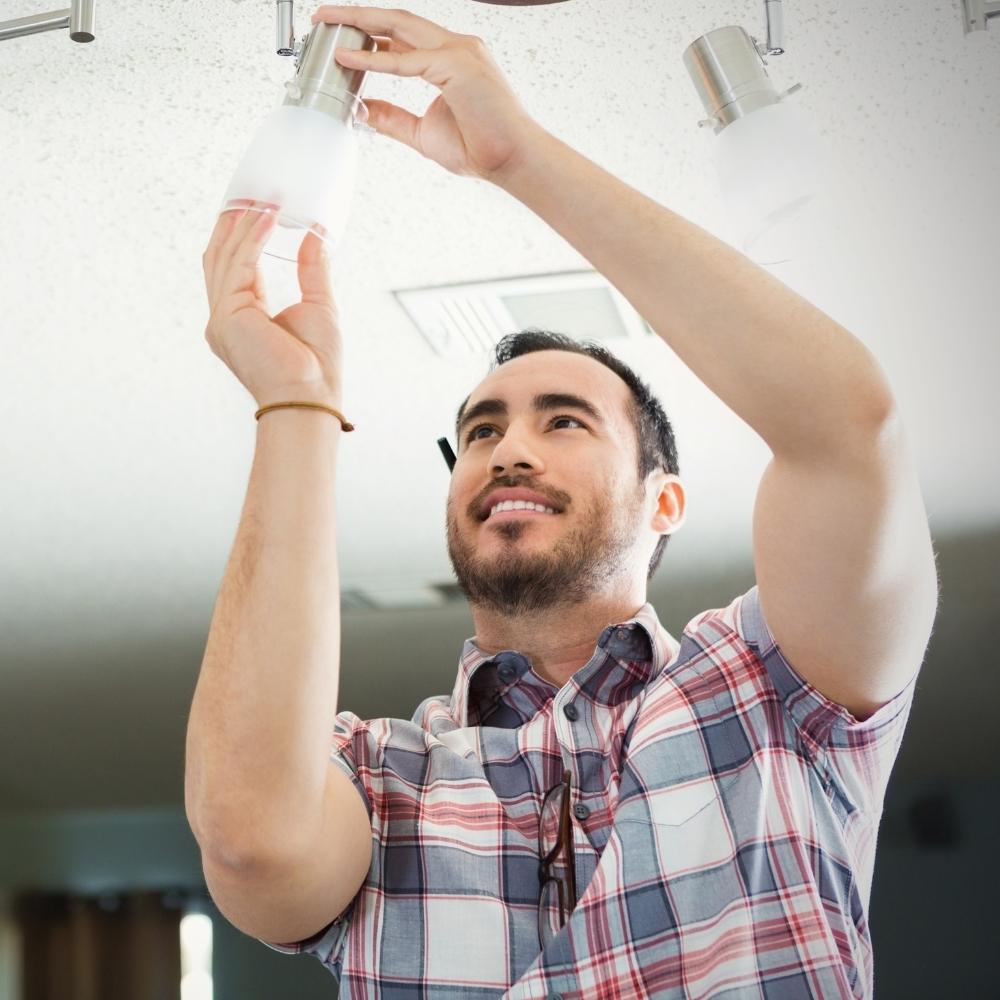 A man change the bulb of light fixtures